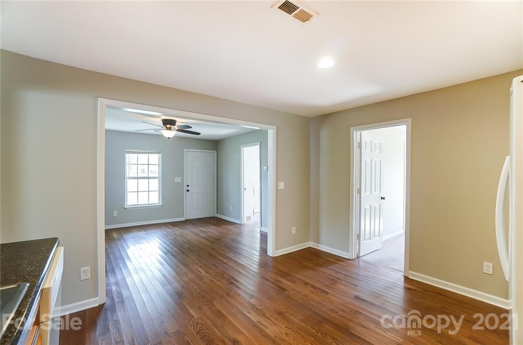 3003 Lowell Road Gastonia, NC 28054 - Photo 6 of 27 an empty room with wooden floor and windows