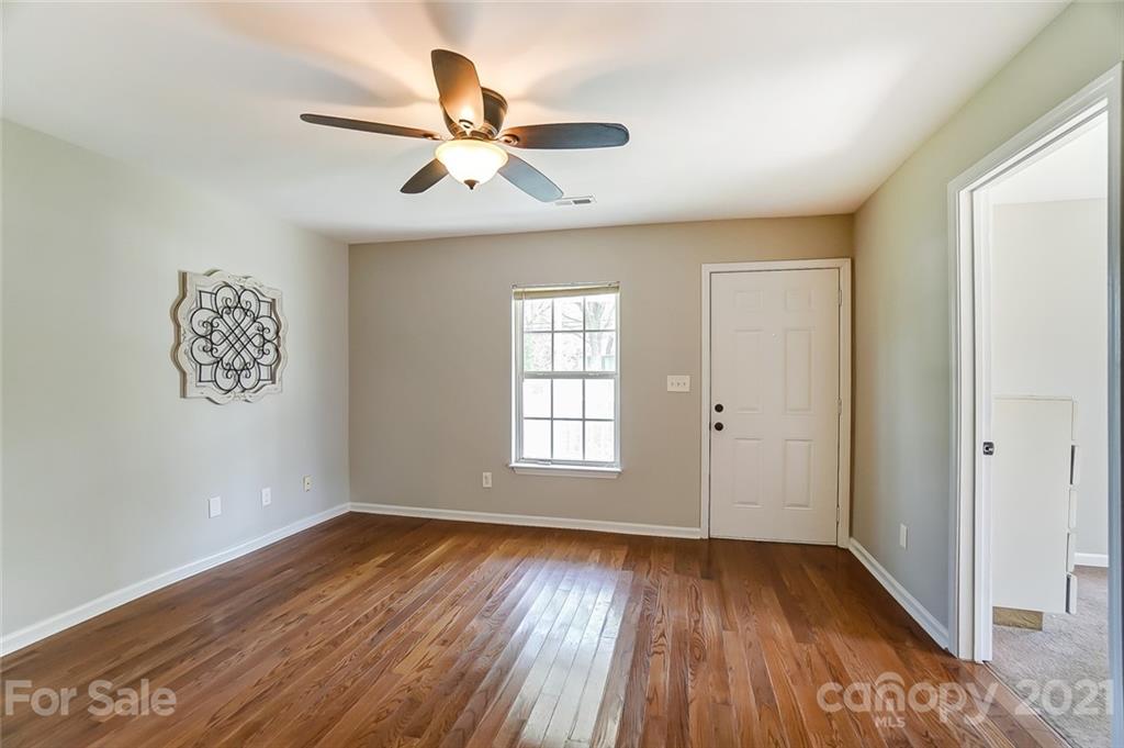 3003 Lowell Road Gastonia, NC 28054 - Photo 7 of 27 a view of an empty room with wooden floor and a window