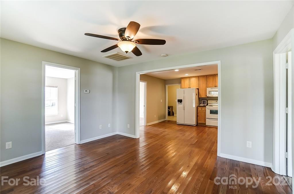 3003 Lowell Road Gastonia, NC 28054 - Photo 9 of 27 a view of empty room with wooden floor and fan