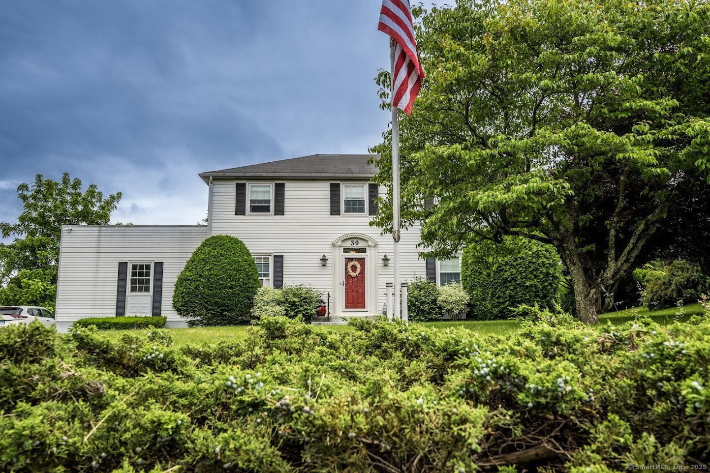 a front view of a house with garden