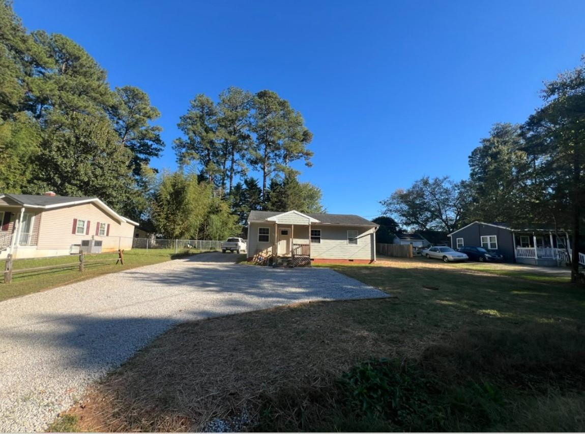 222 Weston Road Garner, NC 27529 - Photo 21 of 27 a front view of a house with a yard and garage