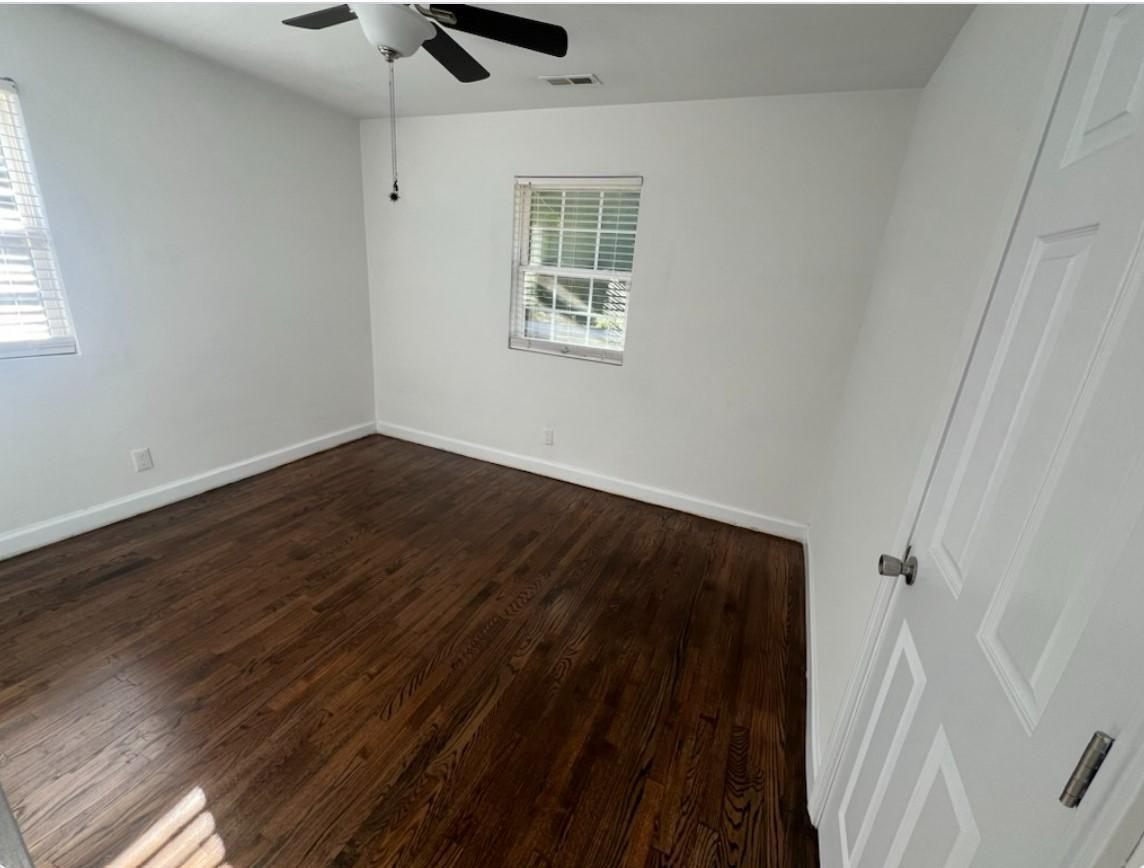 222 Weston Road Garner, NC 27529 - Photo 22 of 27 a view of an empty room with wooden floor and a window
