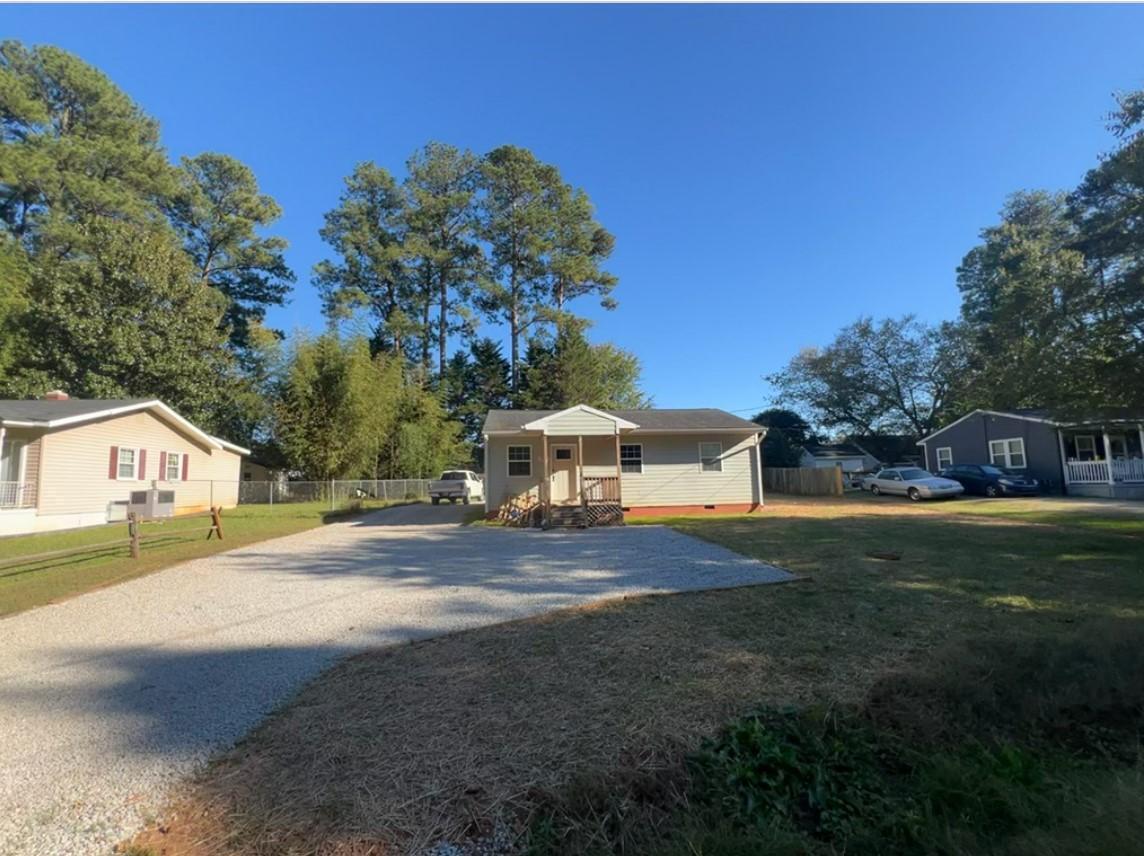 222 Weston Road Garner, NC 27529 - Photo 25 of 27 a view of a house with a yard and large trees