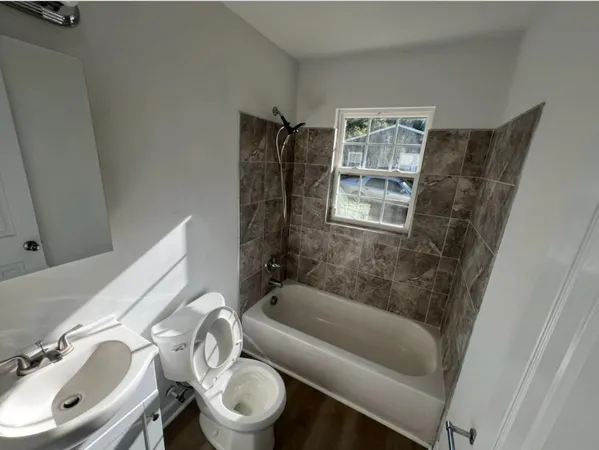 a bathroom with a sink toilet and shower
