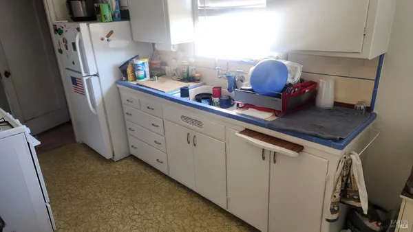 a kitchen with stainless steel appliances a refrigerator and a stove