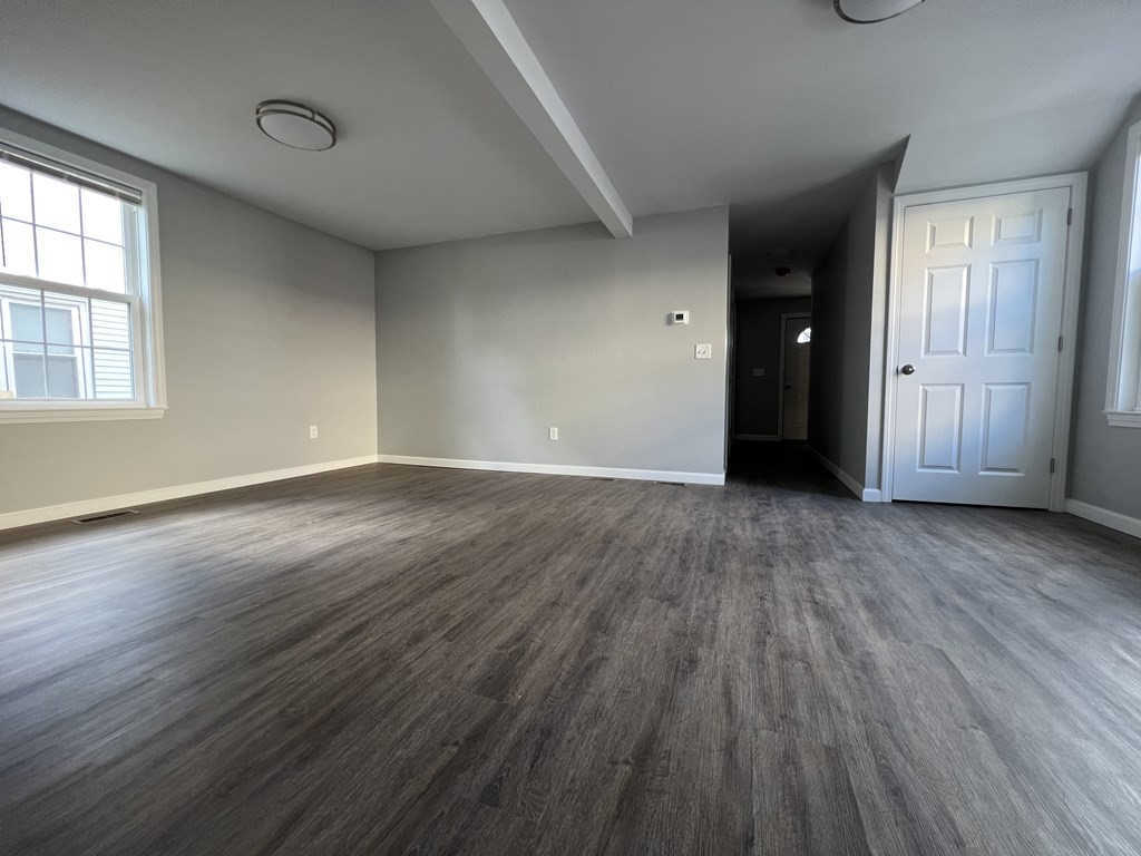 45 Loring Street Springfield, MA 01105 - Photo 9 of 16 a view of an empty room with wooden floor and a window