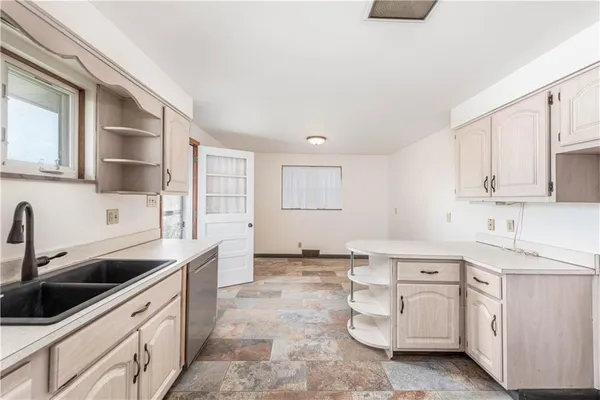 a kitchen with white cabinets and white appliances