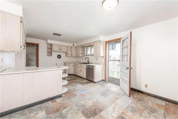 a kitchen with a sink stove and refrigerator