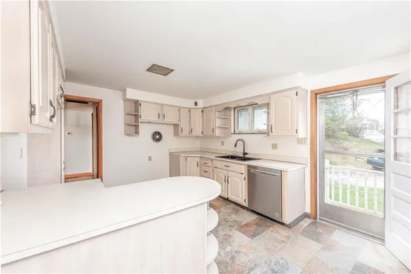 a spacious bathroom with a granite countertop sink and a mirror