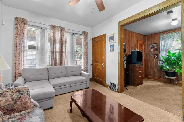 a living room with furniture and large windows