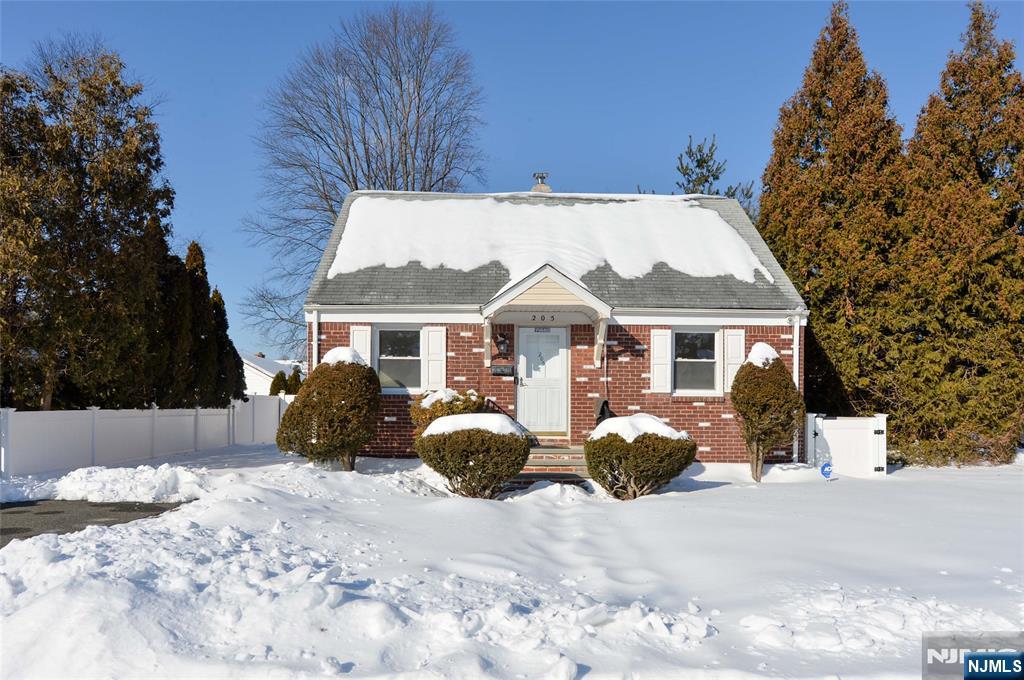 a front view of a house with yard covered in snow