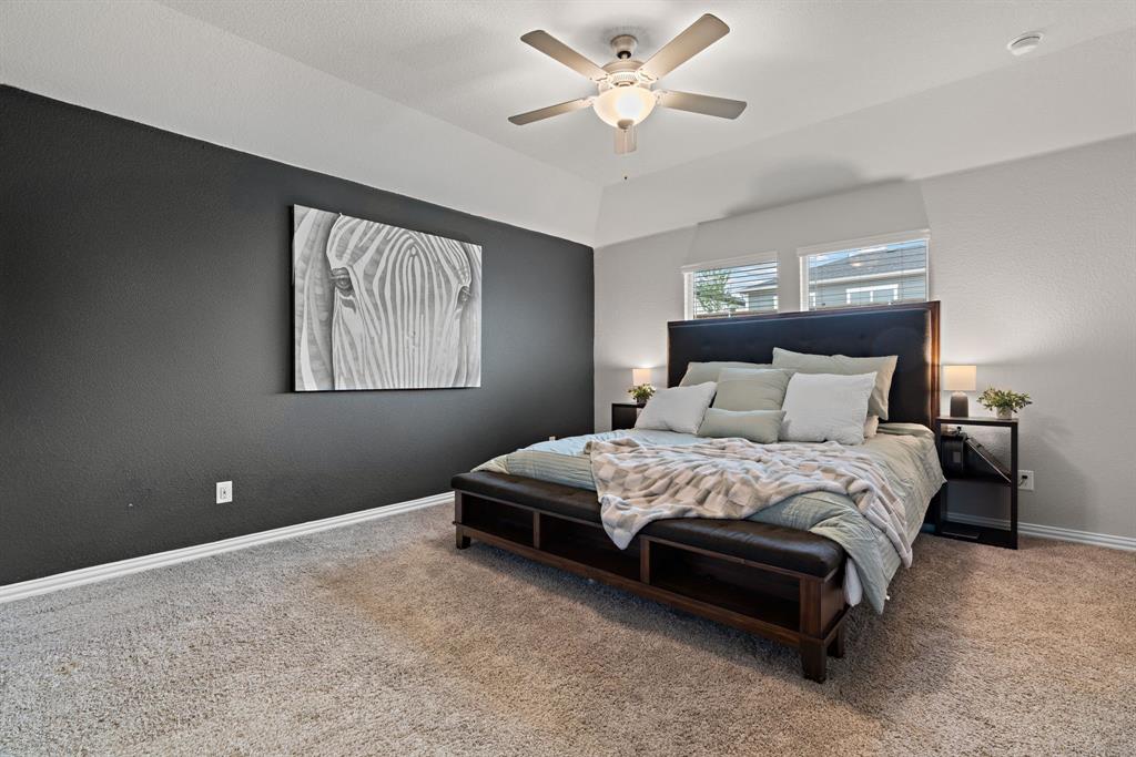 3112 Kingsgarden Road Denton, TX 76207 - Photo 26 of 38 Spacious room featuring vaulted ceilings, a ceiling fan with integrated lighting, twin windows, and neutral carpeting