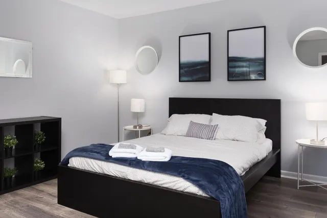 a bedroom with a bed and wooden floor