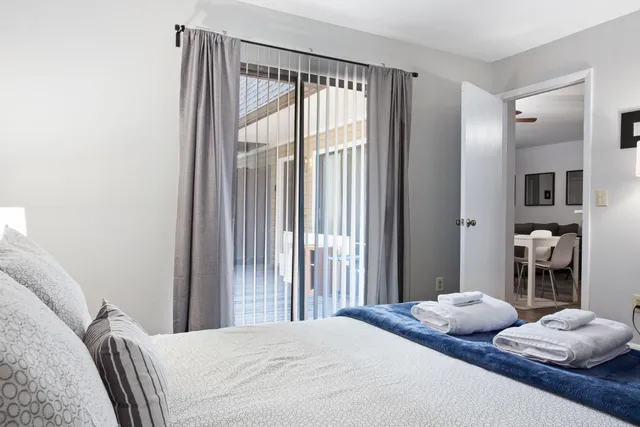 a bedroom with a bed and a large mirror