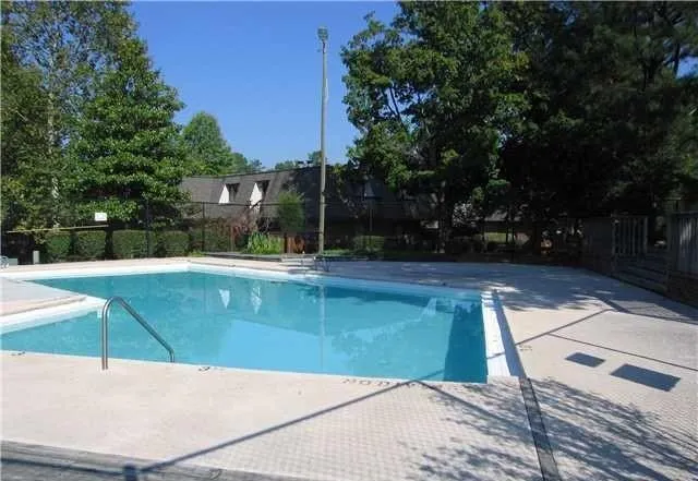 a view of a swimming pool with an outdoor seating