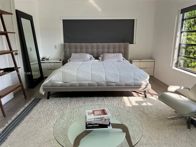 a bedroom with a bed and a mirror