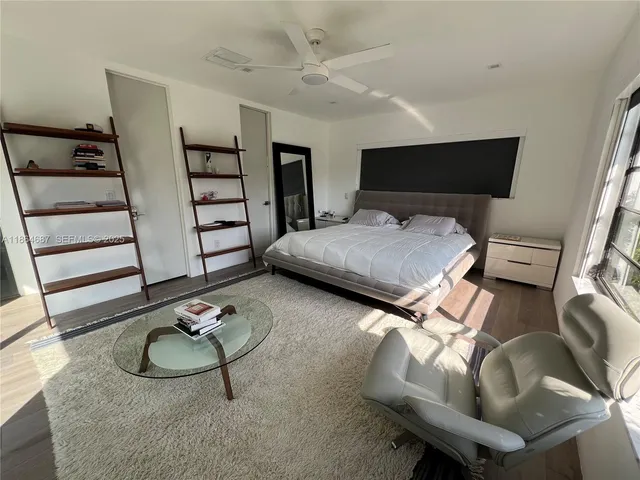 a living room with furniture and floor to ceiling window