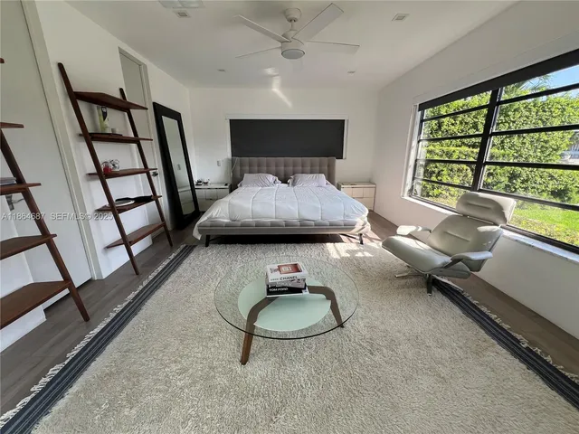 a bedroom with furniture and a window