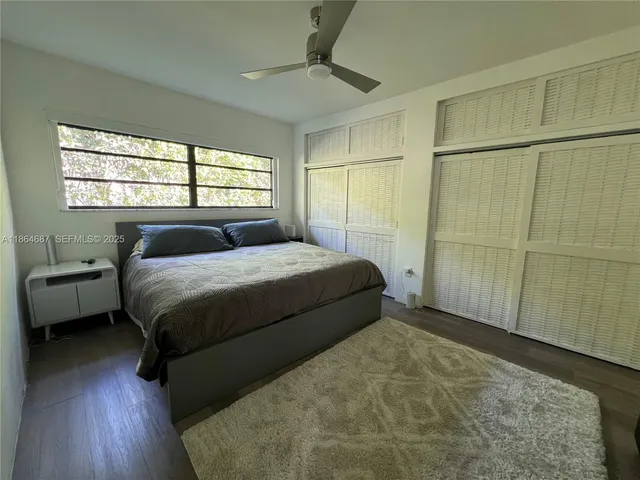 a bedroom with a bed mirror and a window