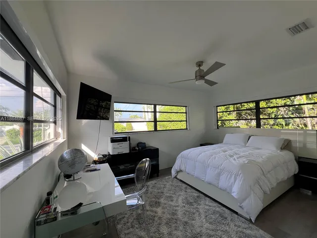 a bedroom with a bed window and wall painting