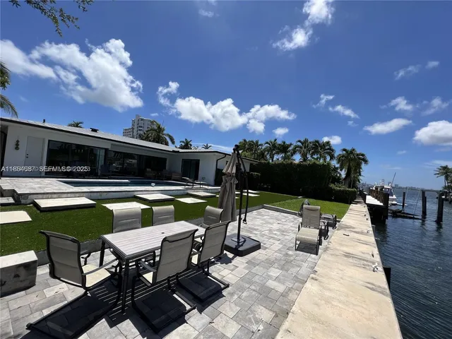 a view of a patio with swimming pool table and chairs