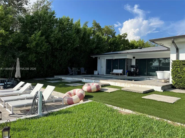 a view of a house with swimming pool and porch with furniture