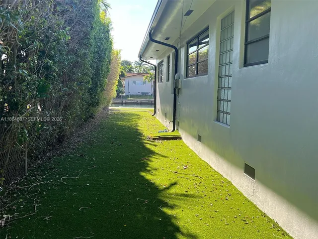 a view of a house with a yard and sitting area