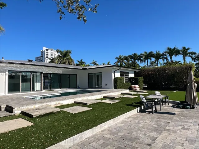 a view of a house with backyard sitting area and garden