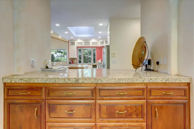 a kitchen with stainless steel appliances granite countertop a refrigerator and a sink
