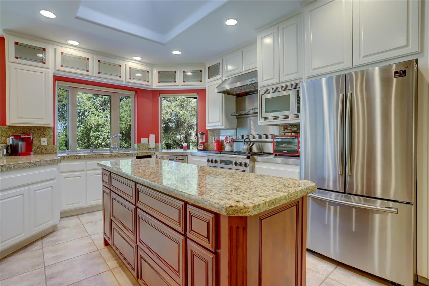 16875 Southridge Road Penn Valley, CA 95946 - Photo 15 of 89 a kitchen with stainless steel appliances granite countertop a refrigerator a sink and a large window