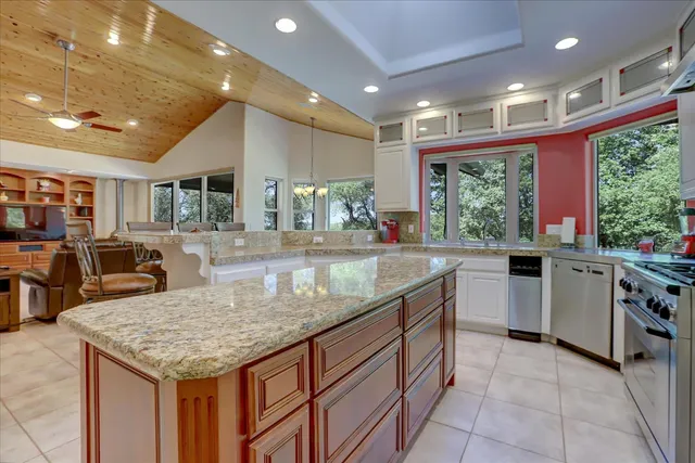 a living room with furniture and a floor to ceiling window