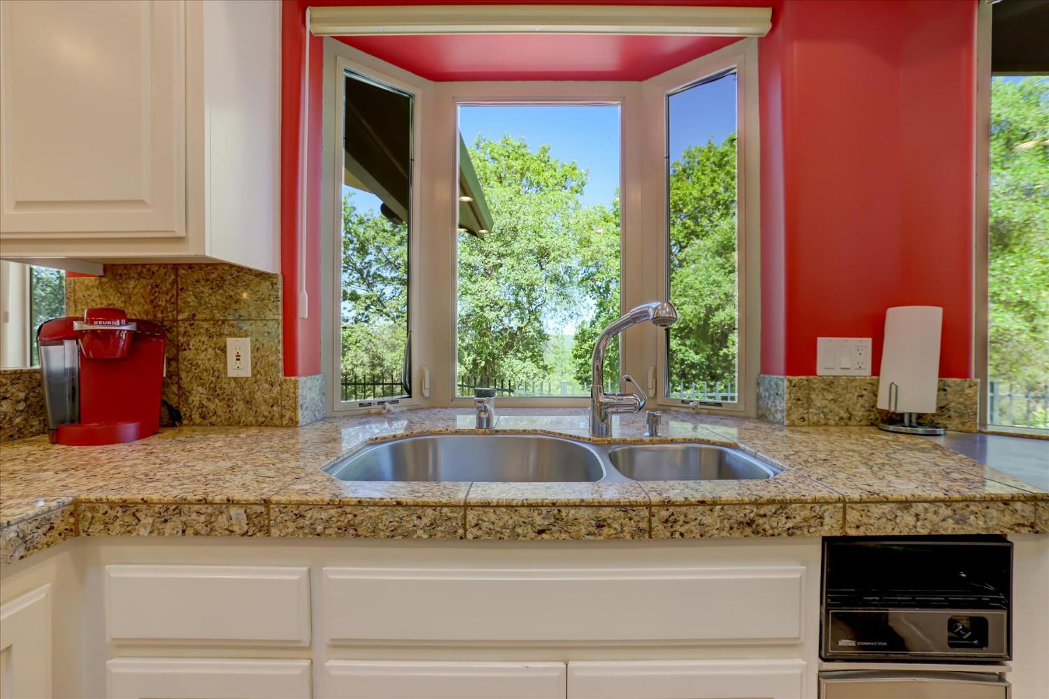 16875 Southridge Road Penn Valley, CA 95946 - Photo 20 of 89 a kitchen sink with granite countertop a large window and a sink