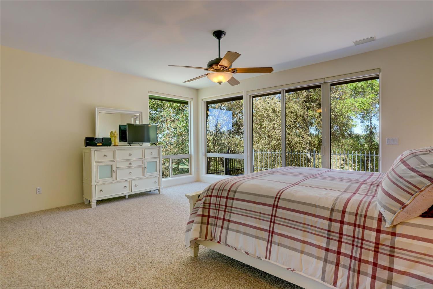 16875 Southridge Road Penn Valley, CA 95946 - Photo 29 of 89 a bedroom with a bed dresser and a large window