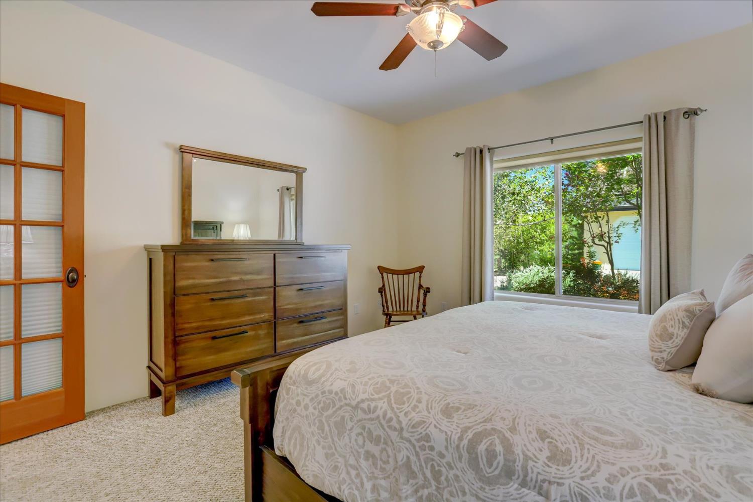 16875 Southridge Road Penn Valley, CA 95946 - Photo 39 of 89 a bedroom with a bed and a chandelier