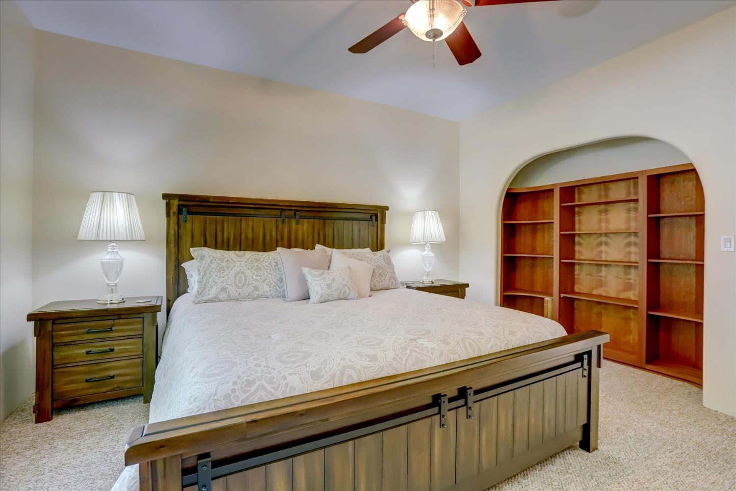 16875 Southridge Road Penn Valley, CA 95946 - Photo 40 of 89 a bedroom with a bed and a chandelier