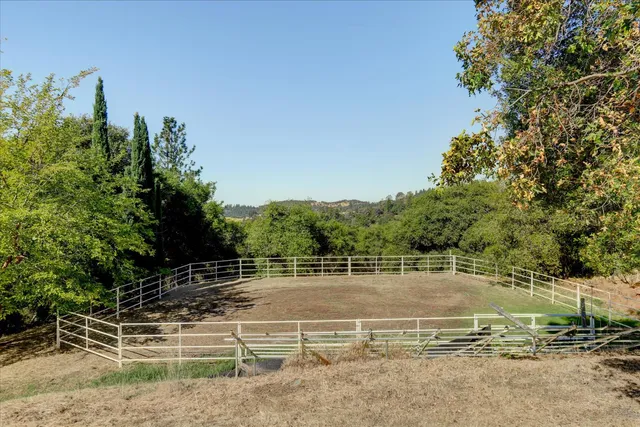 a view of a dining room with furniture a chandelier and window