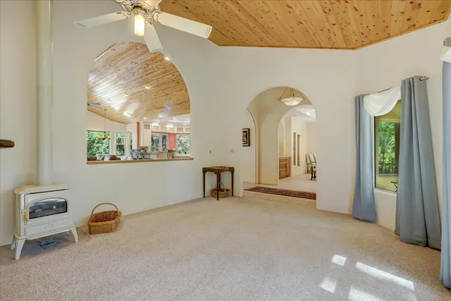 a kitchen with stainless steel appliances kitchen island granite countertop a table chairs and a refrigerator