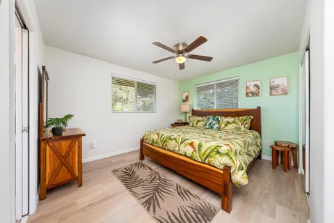 a bed sitting in a bedroom next to a window