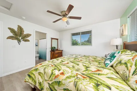 a bed sitting in a bedroom and a chandelier