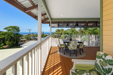 a view of a chairs and table in patio with wooden floor