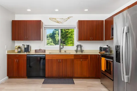 a kitchen with stainless steel appliances granite countertop a refrigerator and a sink