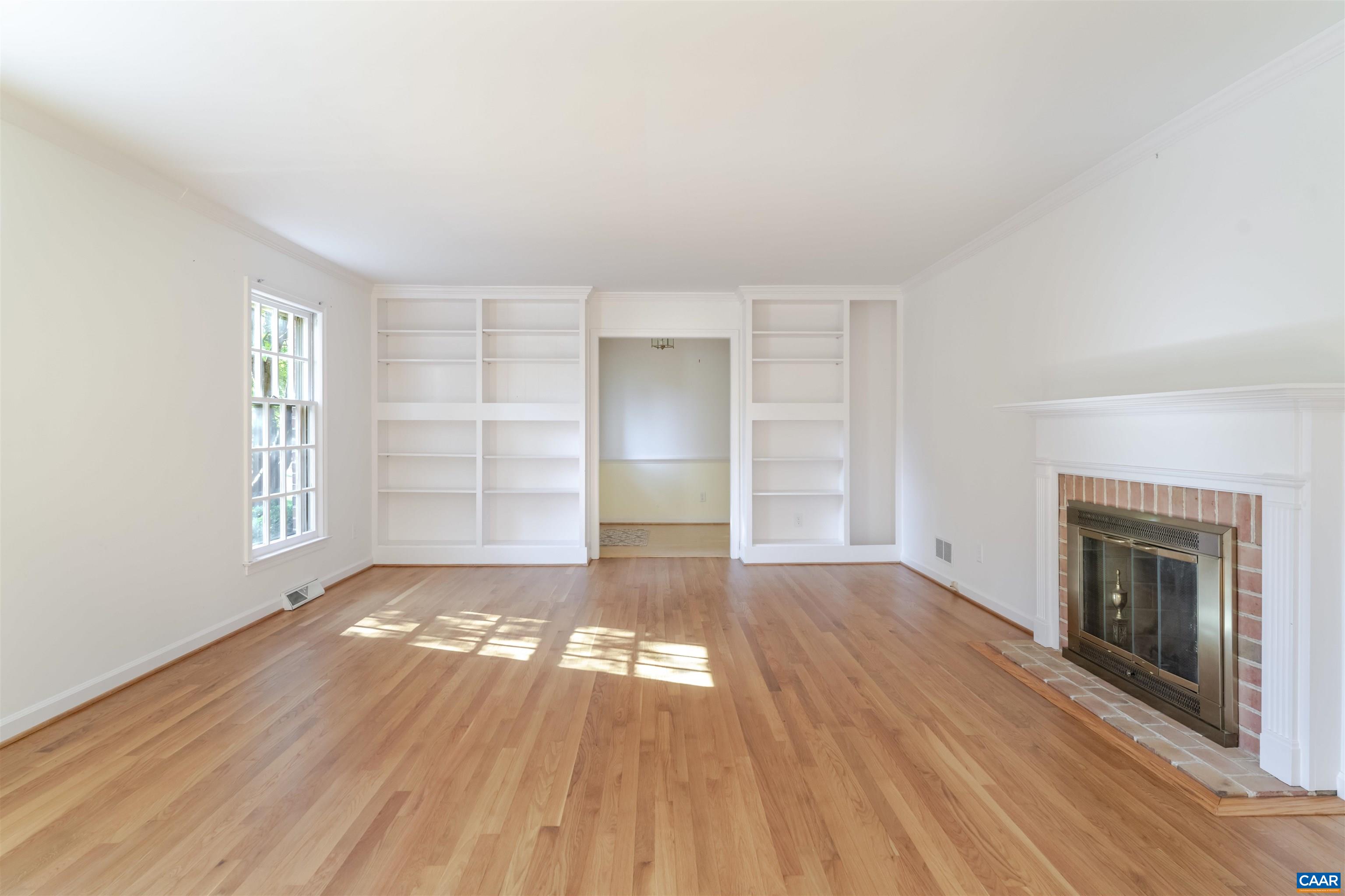 207 Surrey Road Charlottesville, VA 22901 - Photo 8 of 38 Built in bookshelves and connected to both the foyer and family room.