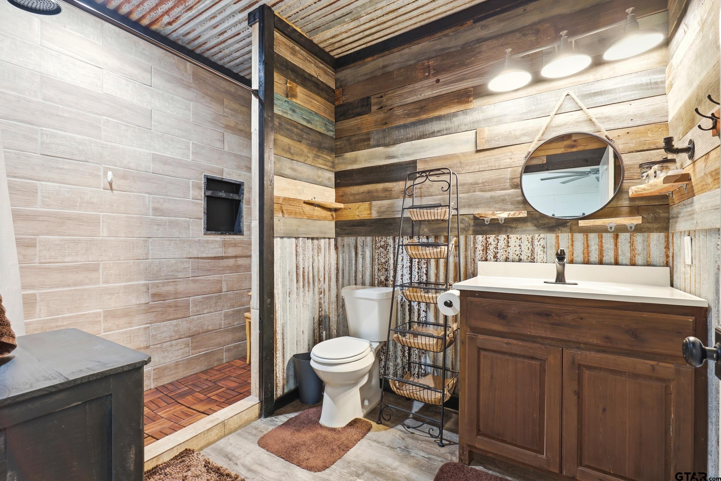 132 King George Road Scroggins, TX 75480 - Photo 15 of 35 a bathroom with a toilet a sink and mirror