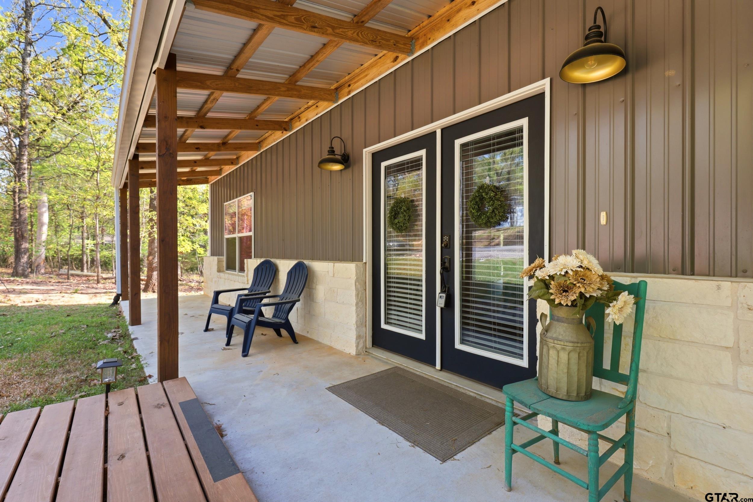 132 King George Road Scroggins, TX 75480 - Photo 18 of 35 a view of a porch with chairs and potted plants