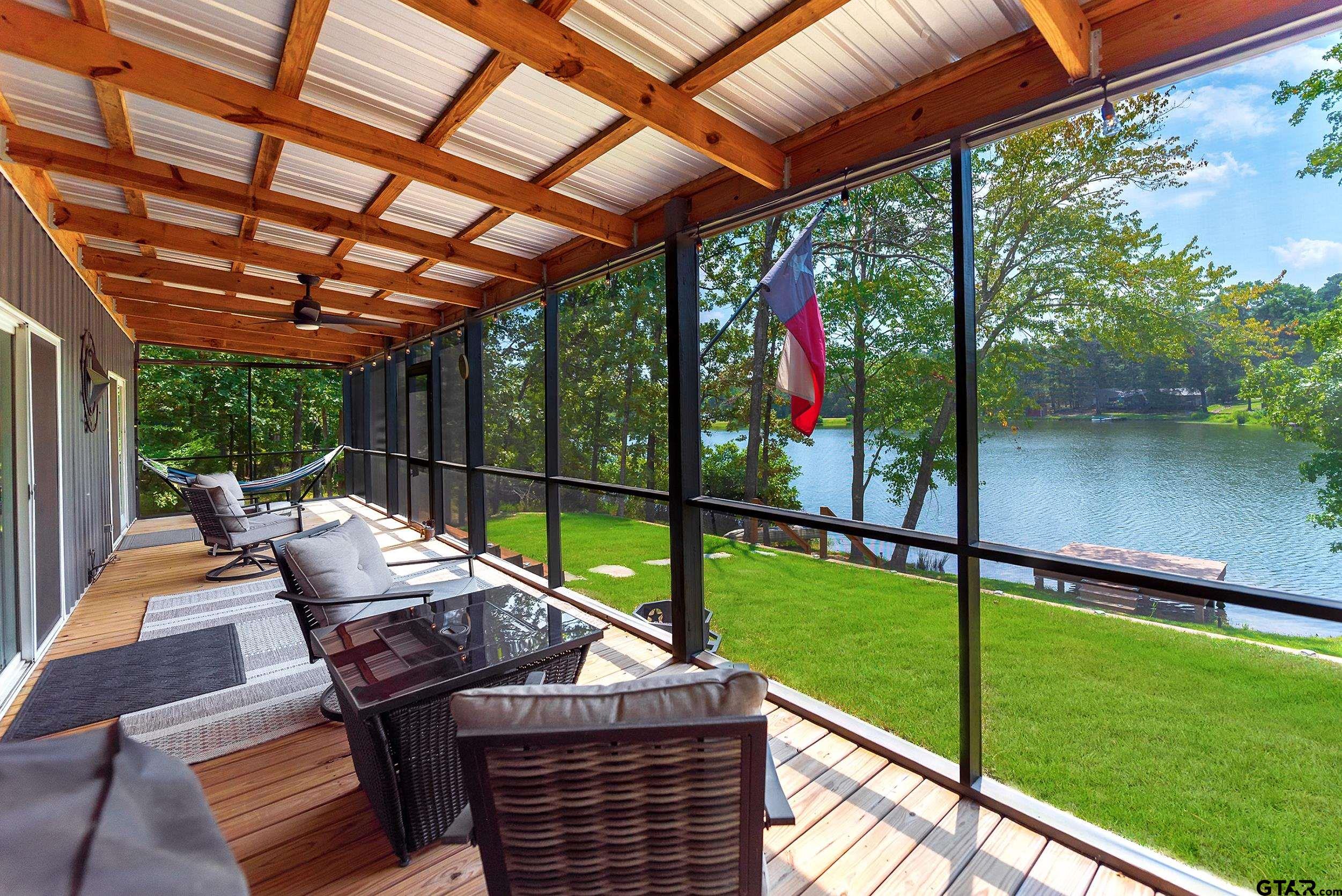 132 King George Road Scroggins, TX 75480 - Photo 23 of 35 a view of a patio with a table chairs and a backyard