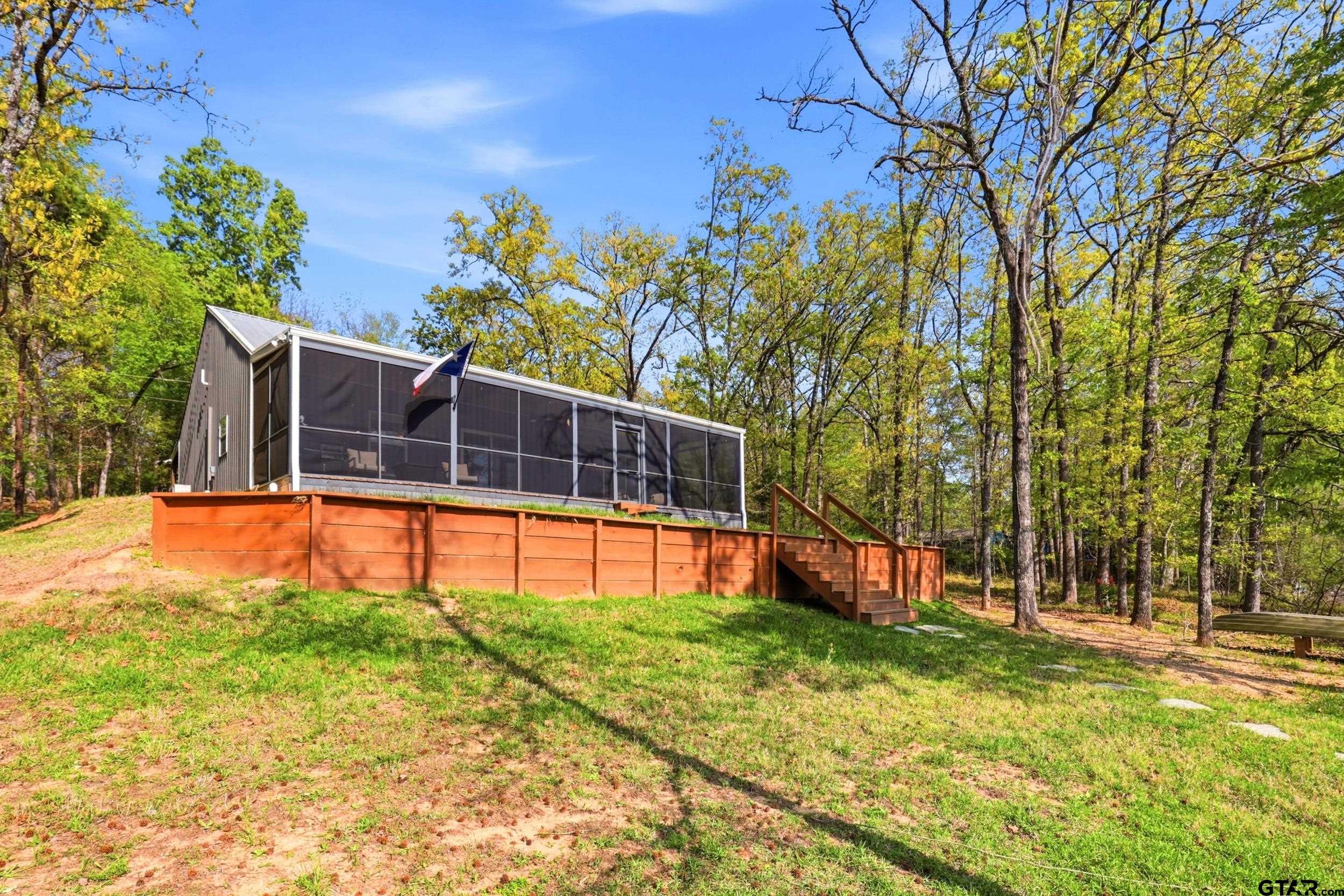 132 King George Road Scroggins, TX 75480 - Photo 29 of 35 a view of a house with backyard and tree