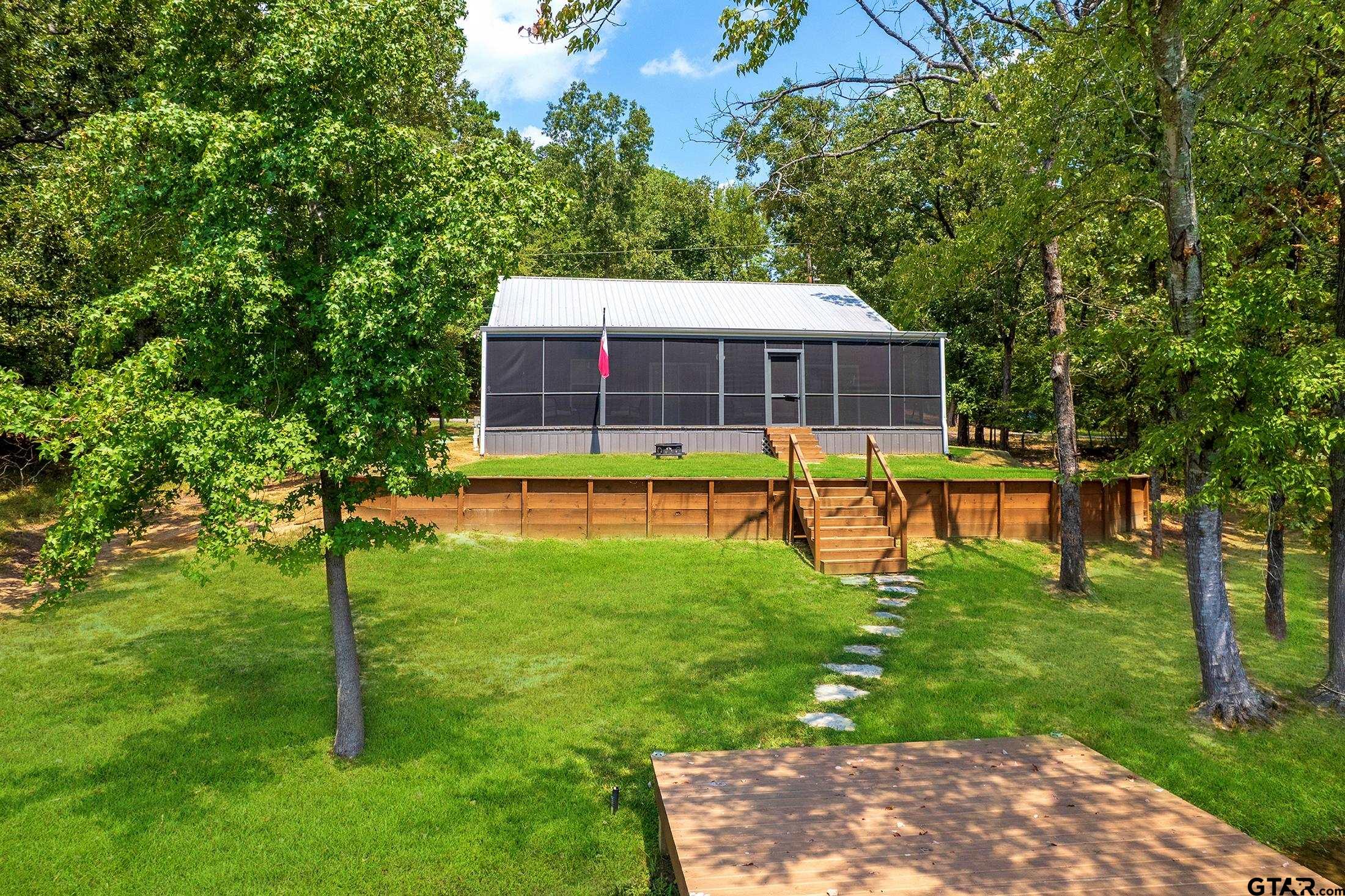 132 King George Road Scroggins, TX 75480 - Photo 3 of 35 a view of a house with a backyard patio and swimming pool