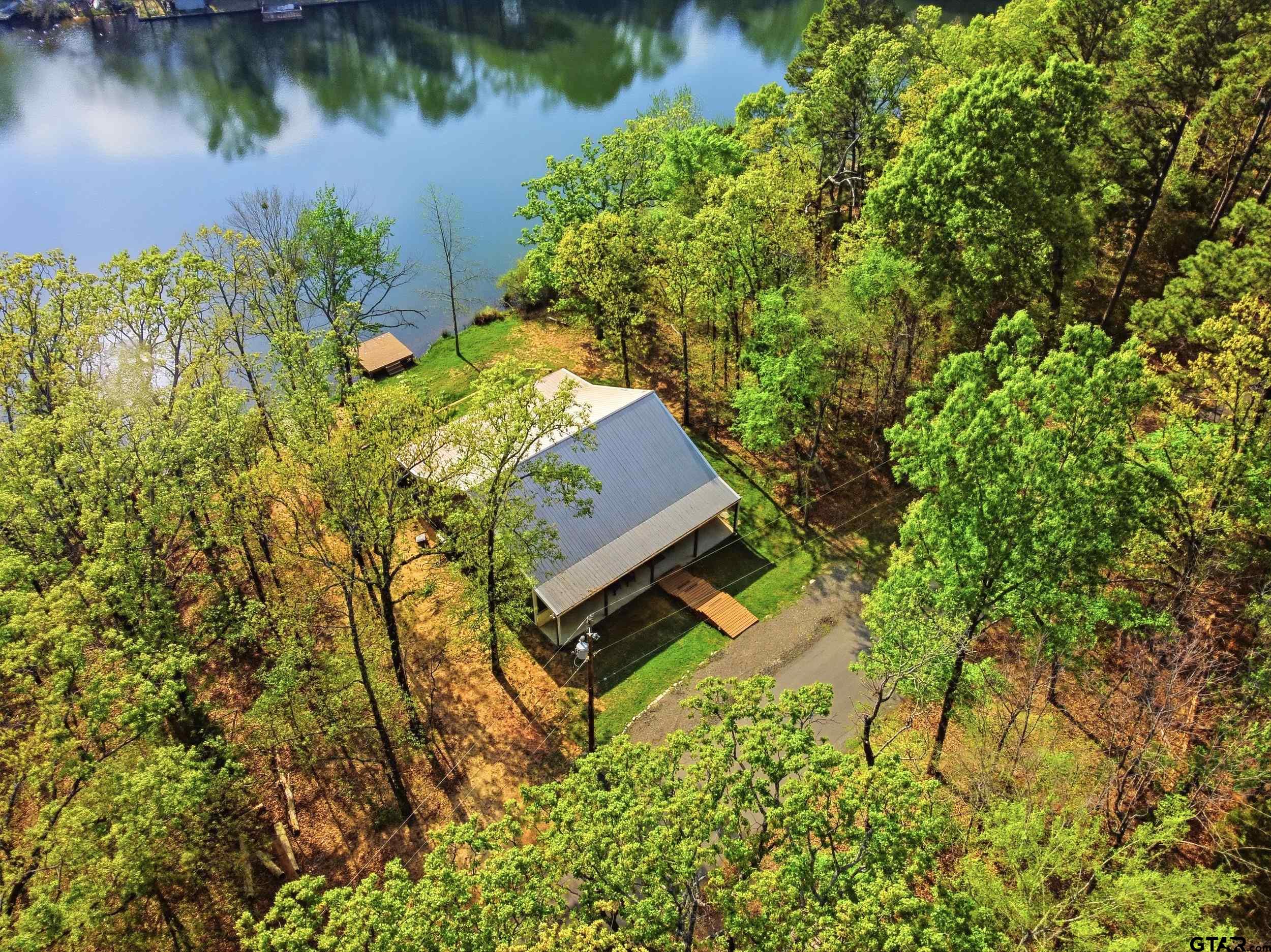 132 King George Road Scroggins, TX 75480 - Photo 31 of 35 a view of a yard with plants and large trees
