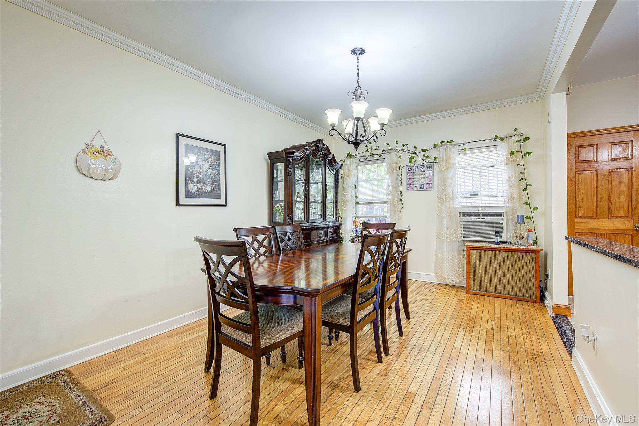 161-10 84th Road Queens, NY 11432 - Photo 12 of 44 a view of a dining room with furniture and wooden floor