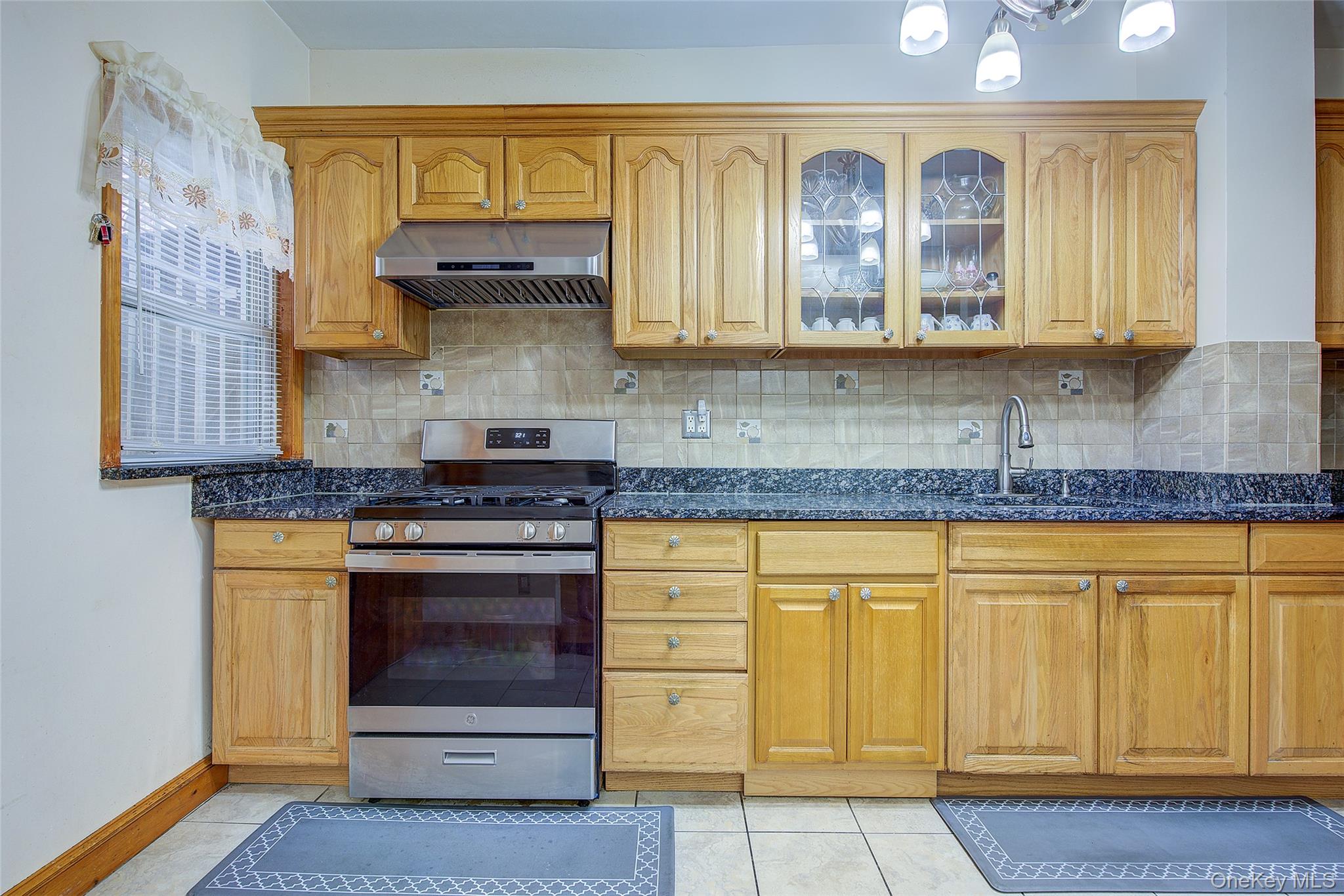161-10 84th Road Queens, NY 11432 - Photo 15 of 44 a kitchen with stainless steel appliances granite countertop a stove and cabinets